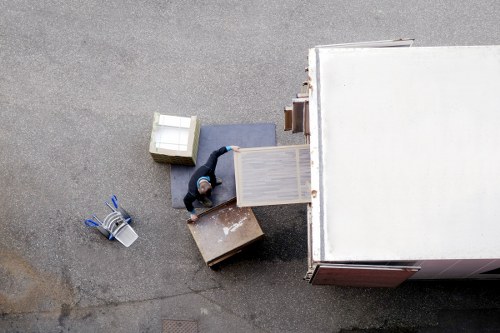 Workers loading furniture into a removal van with care