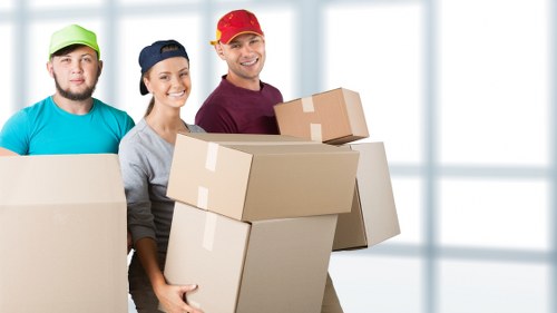 Packed boxes and furniture ready for collection by local movers