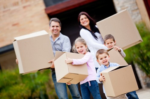 Professional movers loading household furniture and packed boxes