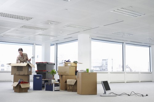 Professional movers handling furniture and IT items during a commercial relocation